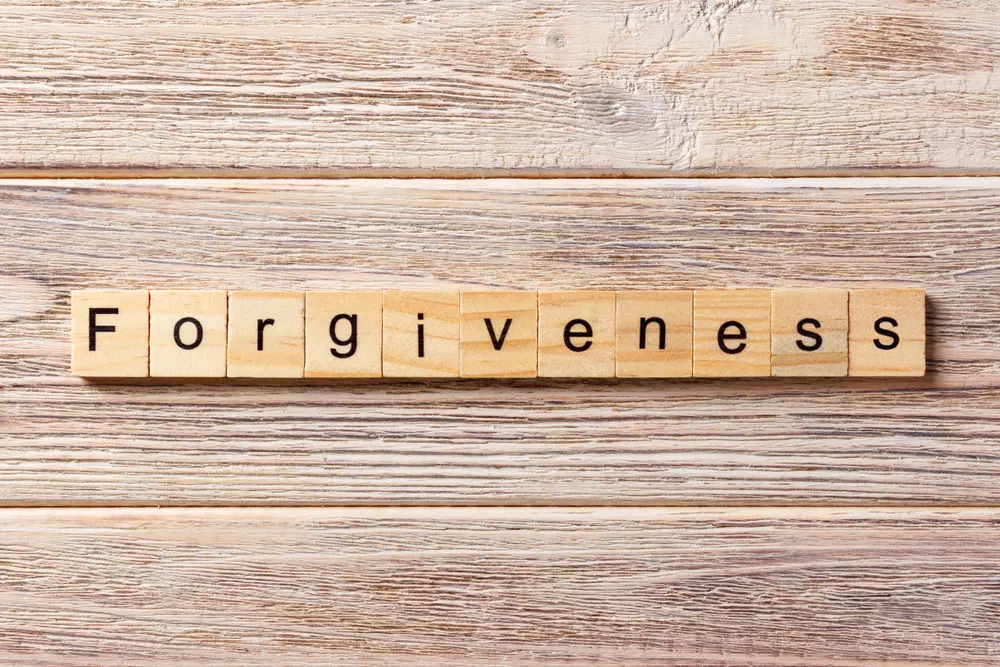 The word "forgiveness" on a board