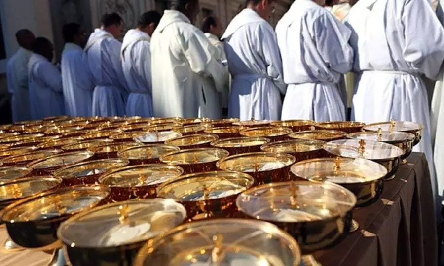 Priests concelebrating Mass and many ciboria